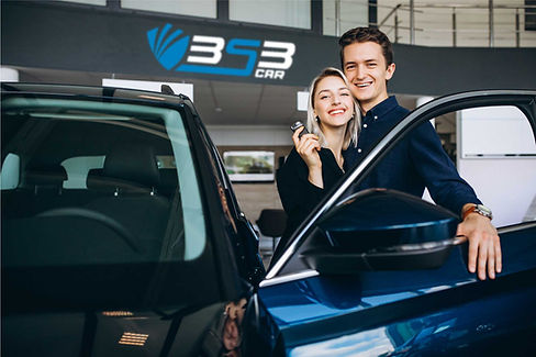 young-couple-choosing-a-car-in-a-car-show-room.jpg