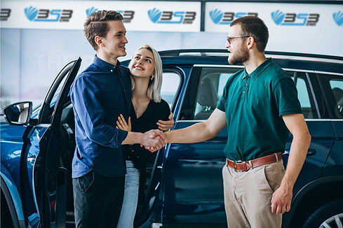 young-family-buying-a-car-in-a-car-showroom-heands.jpg