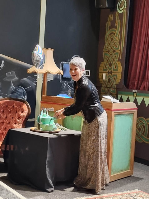 Paula Johnson author, cutting her book launch cake