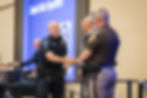 Tulsa Police Officer accepting an award on stage