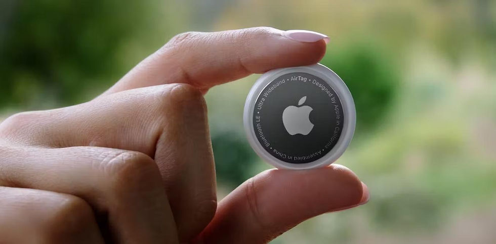 A stock photo of a person holding up an Apple AirTag.