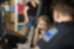 A Tulsa Police Officer letting a child use a radio