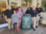 Current and dormer Tulsa Police personnel stand with Tulsa County personnel and Special Olympics athletes outside of a Starbucks