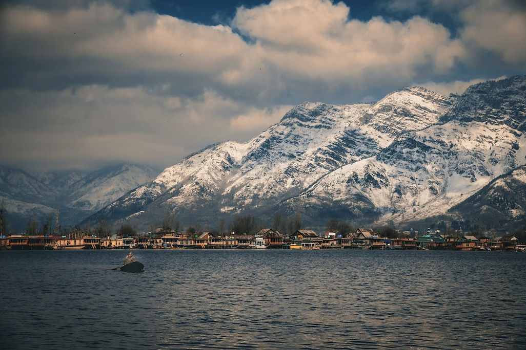 free-photo-of-town-on-a-lake-among-snow-covered-mountains.jpeg