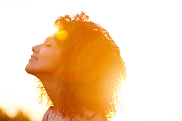 Woman enjoying the sun while listening to SunKiss.radio