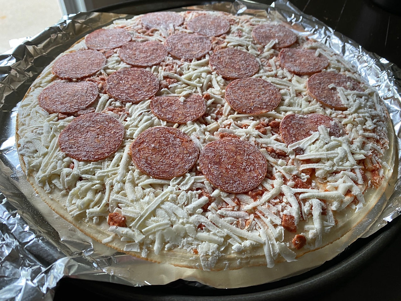 natural light photo of frozen pepperoni pizza still frozen