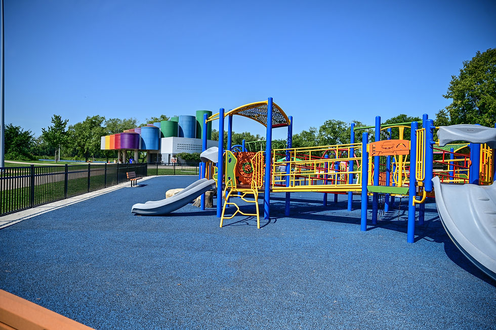 Colorful playground equipment on a bright sunny day against blue sky