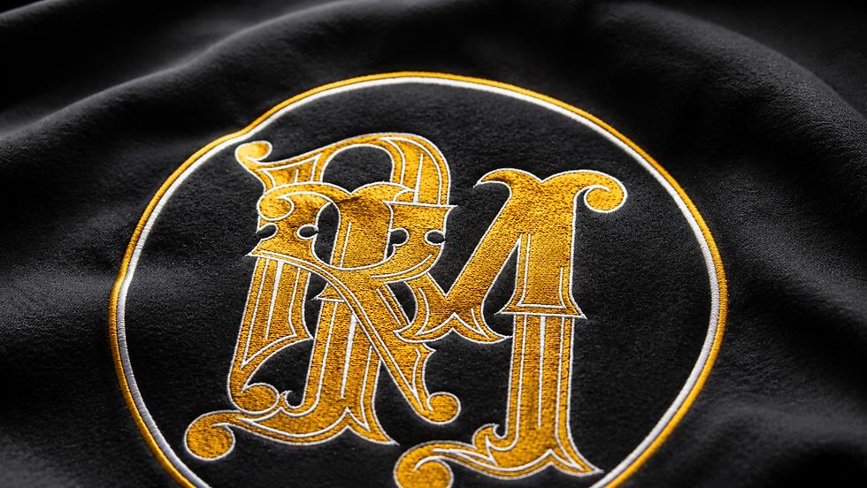 Embroidered gothic RM emblem on black fabric