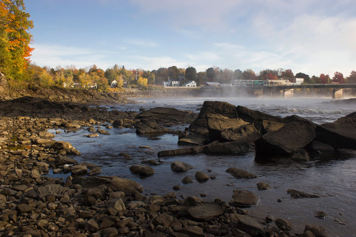 Golden hour lights up a tidal river with the tide out. 