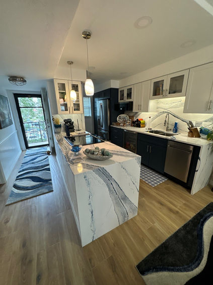 Open space bathroom with dual vanities, large mirrors, and sleek design