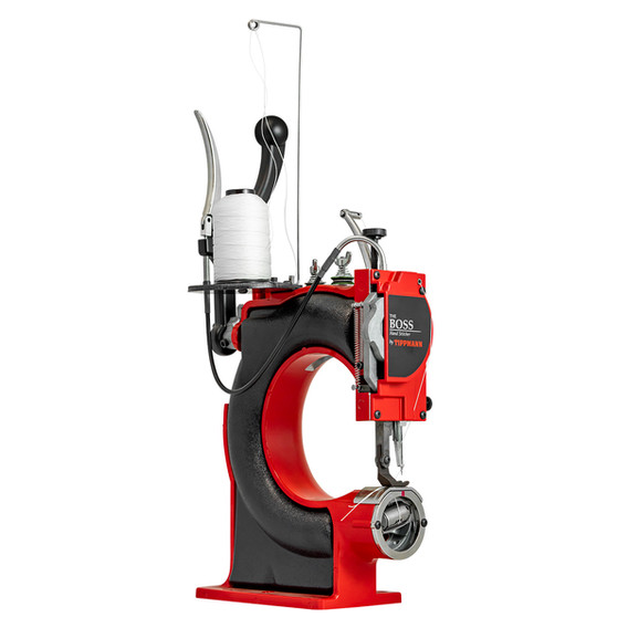 Red and black industrial sewing machine with visible text on the side.