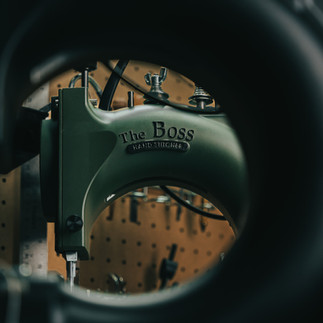 Green sewing machine, The Boss, through a tire's centered lens and background