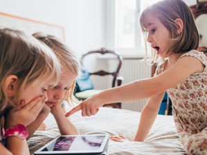 Children playing on an iPad
