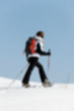 woman-walking-snow-with-rackets.jpg