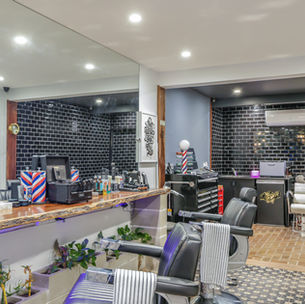 Wide view of Old Sport Barbershop interior with cutting stations