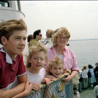 Young Mindy Arbuckle with family on a boat or ferry, representing family roots, shared experiences, and the wider world calling her forward.