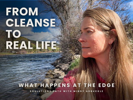Woman reflecting by a river during a cleanse to real life transition