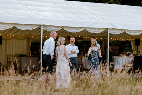 Guests having fun at marquee wedding