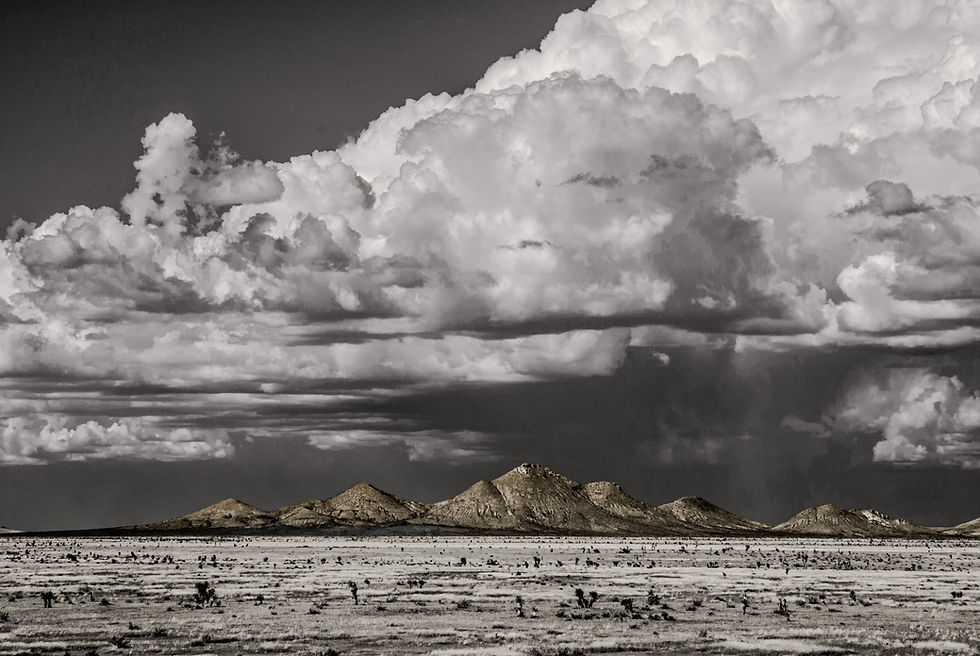 Dramatic storm clouds over a desert mountain range