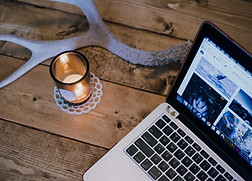A computer, candle, and antler