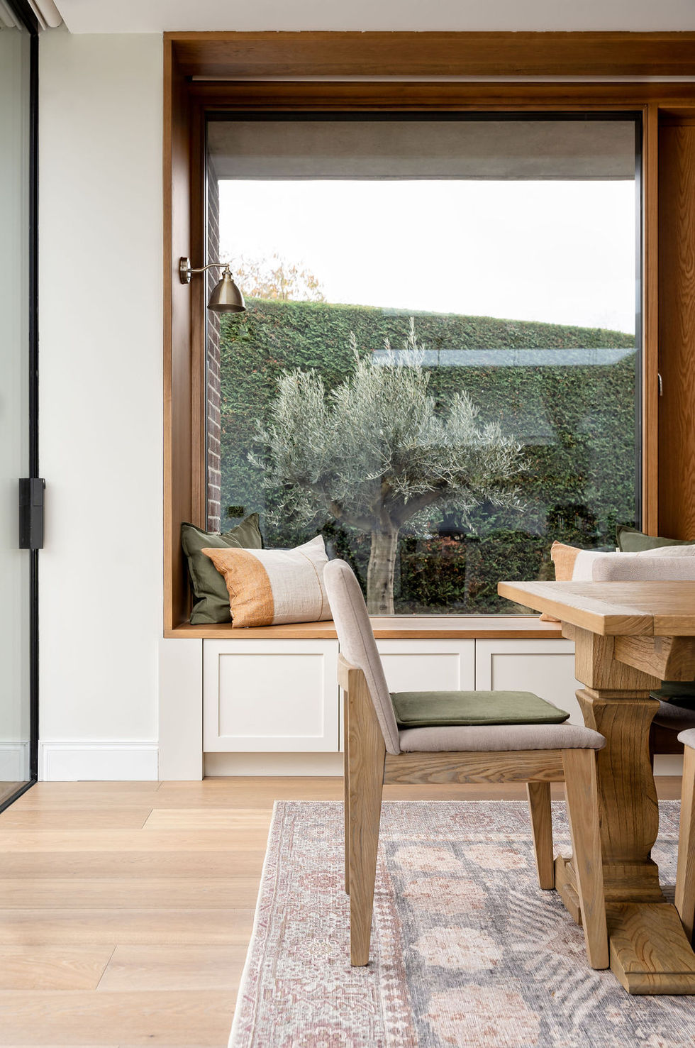 Cozy dining area with large window and garden view.
