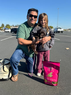man and his daughter holding a puppy