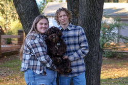 Couple with their Chocolate Australian Labradoodle