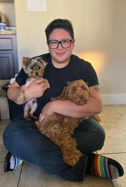 A mom holding her two fur-babies
