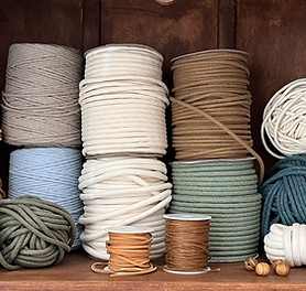 A group of different types of cotton rope and cords.