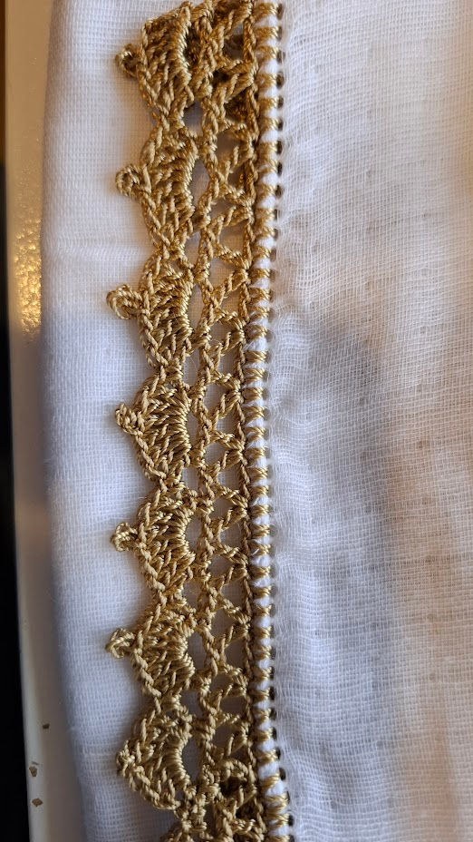 Custom gold crochet edging on muslin