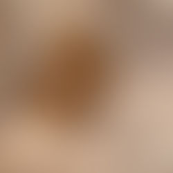 A close-up of cutting board oil being poured on an end-grain cutting board.