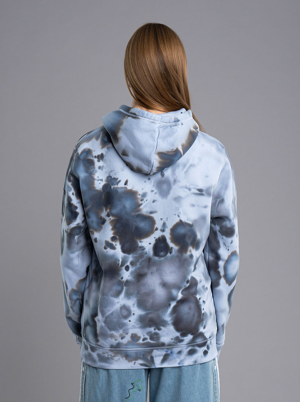 Thumbnail: A girl with an ice-dyed hoodie in black shades form the back up close