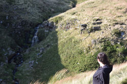 Girl Looking at Waterfall on The Crashed Plane Hike