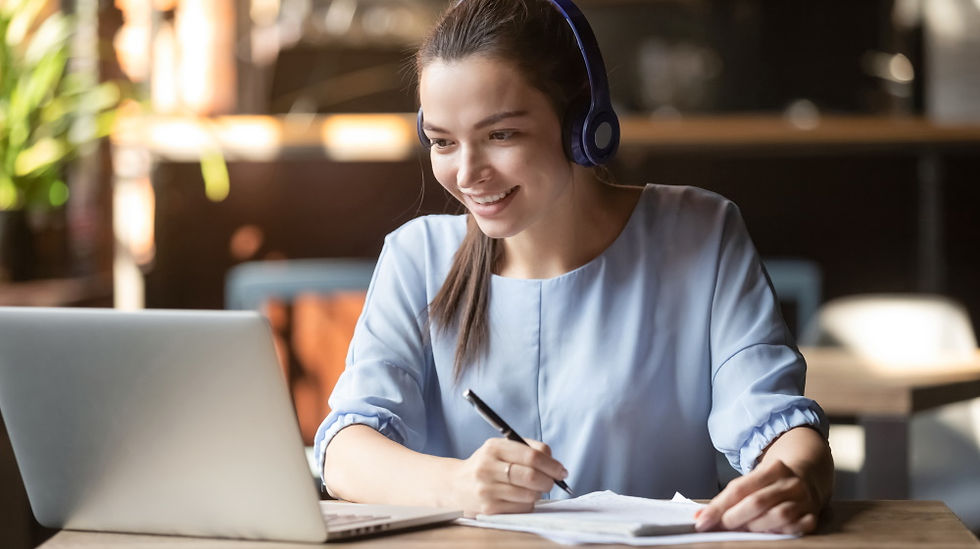 woman sitting at laptop with headphones
