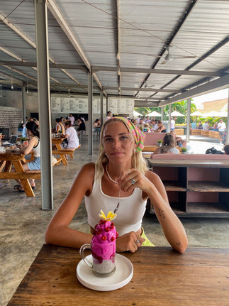 Girl enjoying a smoothie and chia porridge at CRATE Café