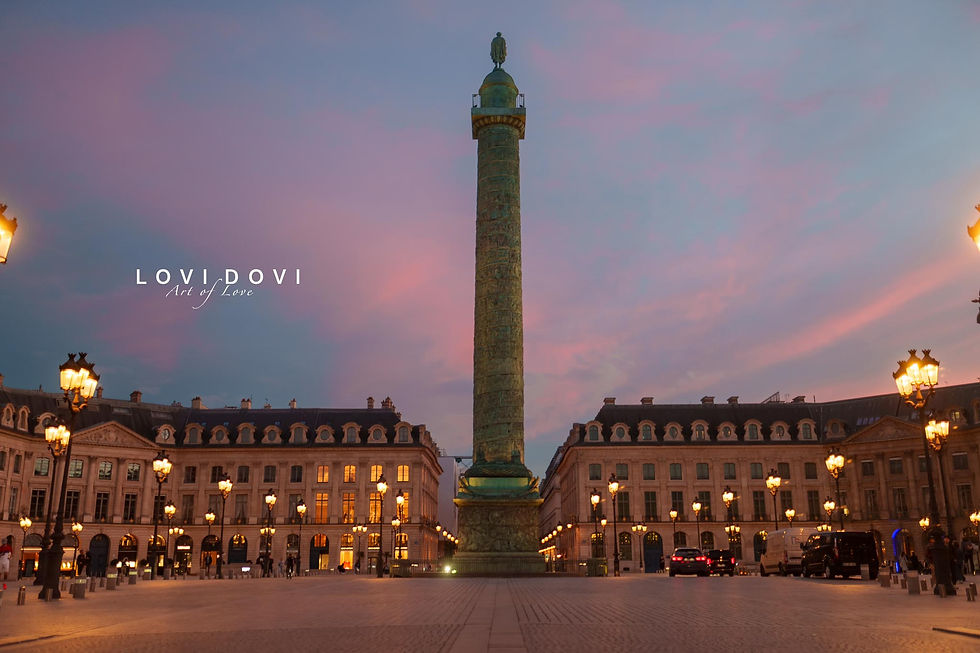 A serene sunset paints the sky in soft hues over Place Vendôme, highlighting the majestic column and elegant architecture, as streetlamps glow warmly below. Photo by lovidovi.art