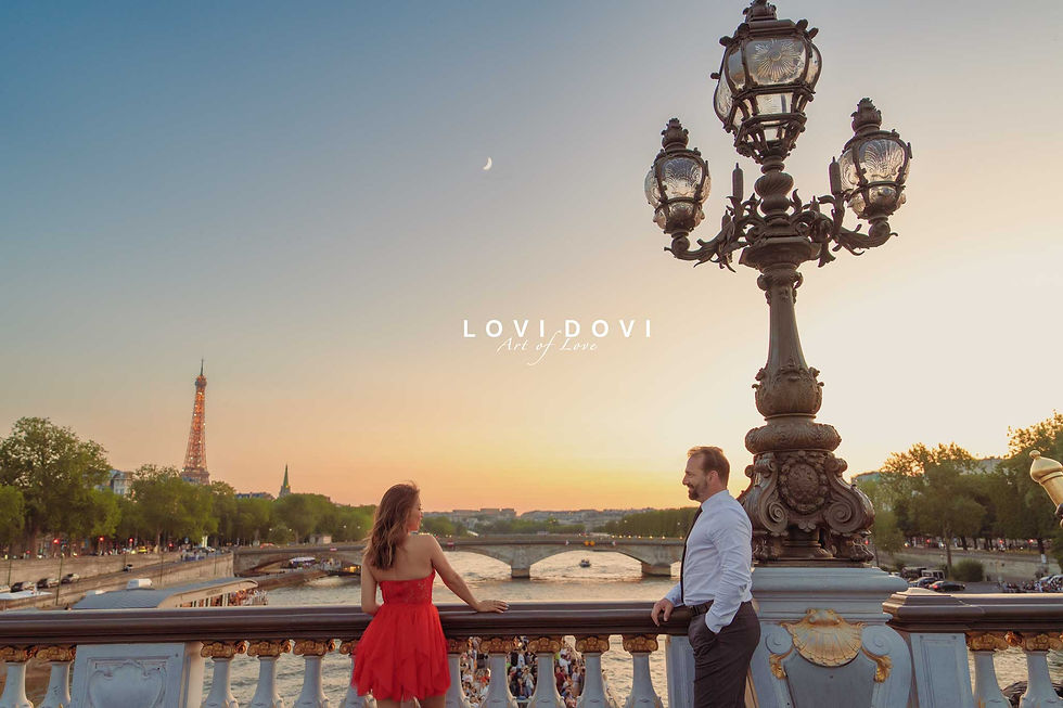 A couple enjoys the romantic sunset on Alexandre III Bridge, with the Eiffel Tower in the background. Photo by lovidovi.art