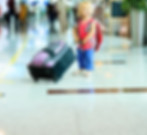 little girl at airport with luggage