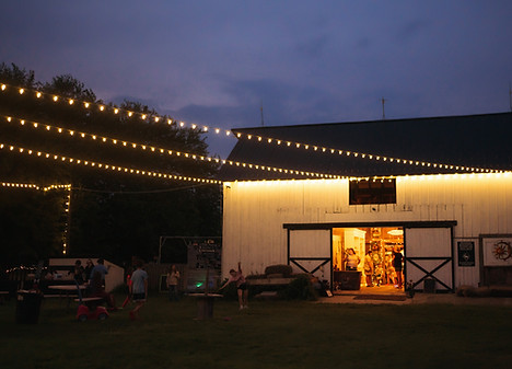 White barn and string lights on a summer festival night in central Illinois