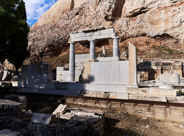 The partly restored Temple of Asclepius below the rock of the Acropolis in Athens