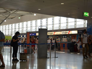 Travelers with luggage in the departures hall of Athens International Airport Eleftherios Venizelos