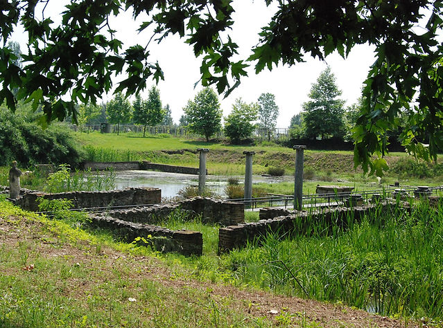 Ruins among trees and grass at the archaeological site of ancient Dion in Pieria