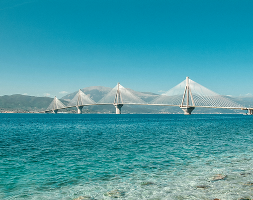 Patras: The modern Rio-Antirrio Bridge at sunset for Patras Golden Visa articles.