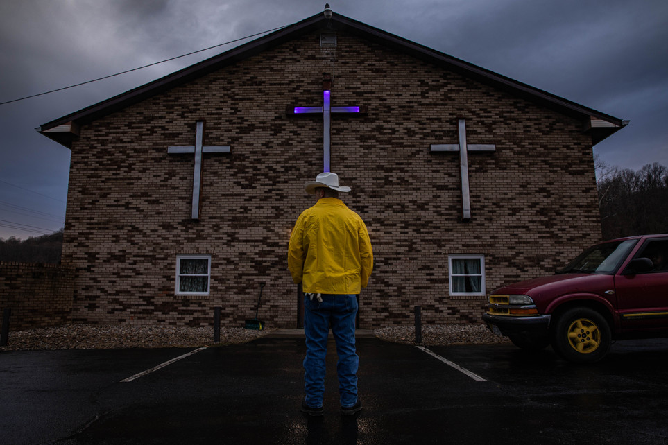 Larry Young directs a line of cars waiting outside the food pantry operated at the River of Life Church in Rutland, Ohio, on March 2, 2021.