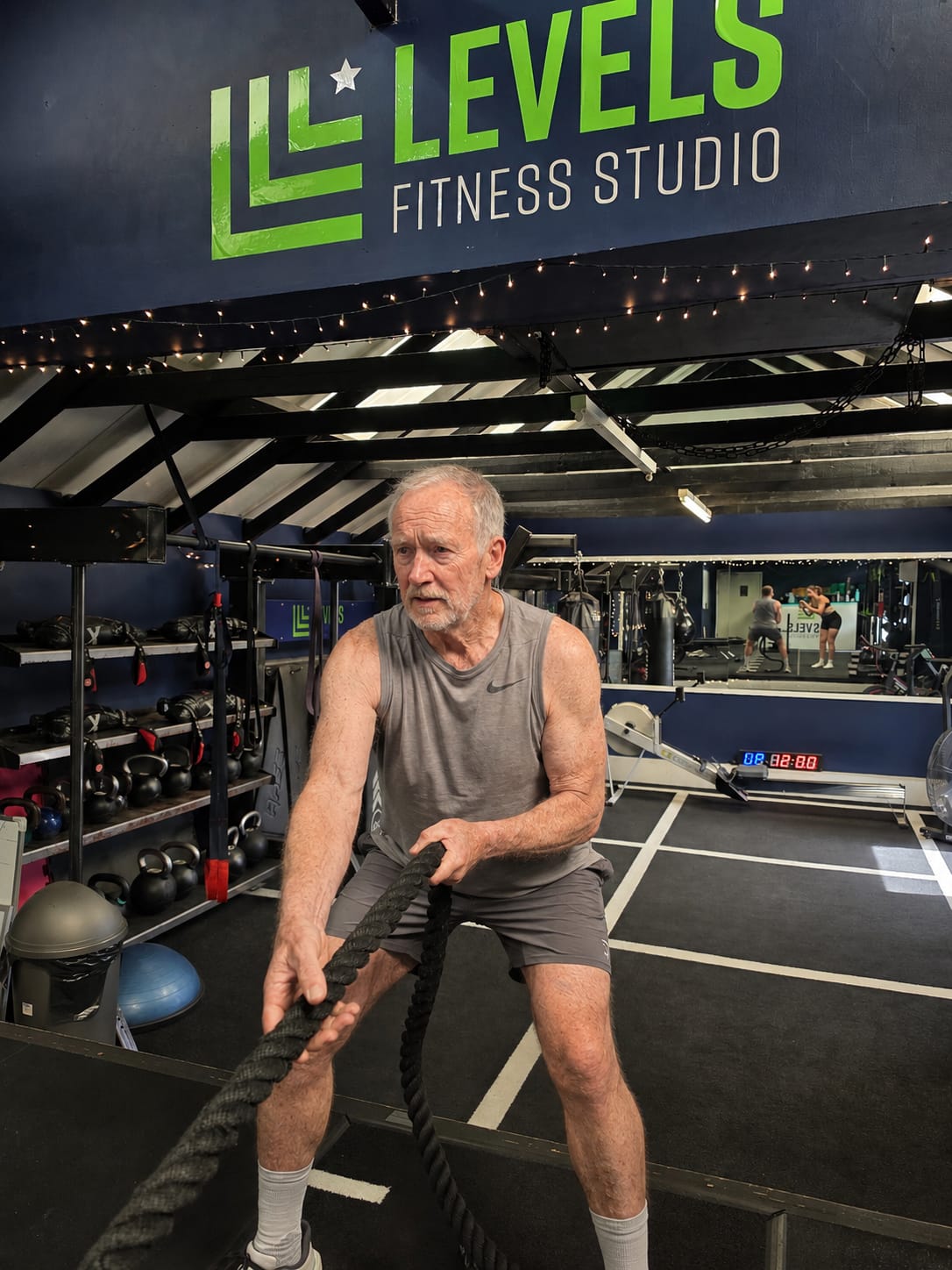 AI generated image of an old man pulling a sled in Levels Fitness Studio. 
