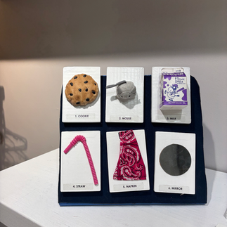 Close-up of another tactile display with labeled objects on a blue stand.