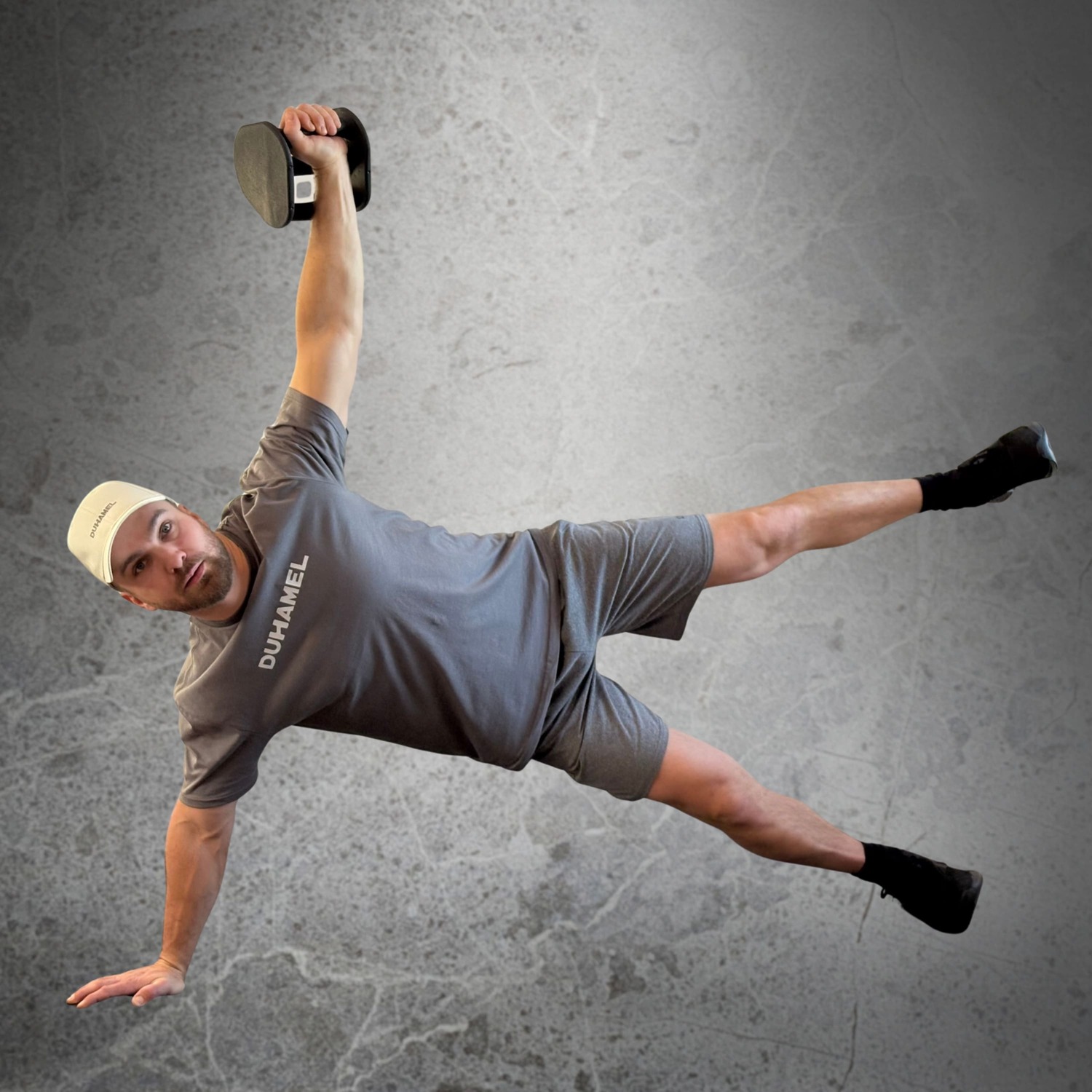 Homme faisant des Kettlebell Spartan Side Plank avec Haltères Duhamel