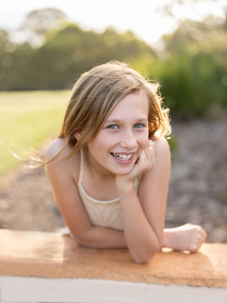 Smiling girl outdoors, daytime portrait