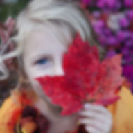 Girl with autumn leaf