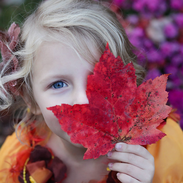 Girl with autumn leaf
